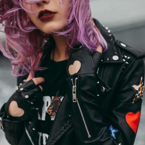 violet haired woman in a leather jacket
