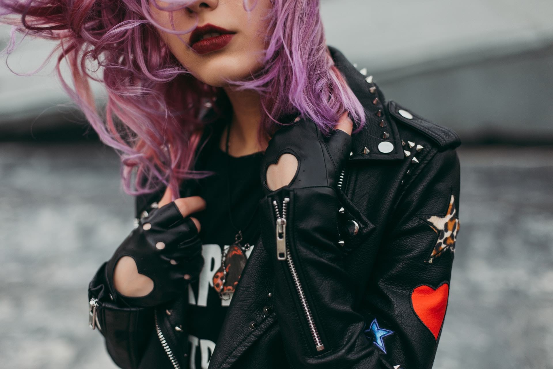 violet haired woman in a leather jacket