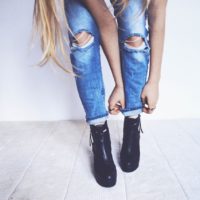 woman in black ankle boots