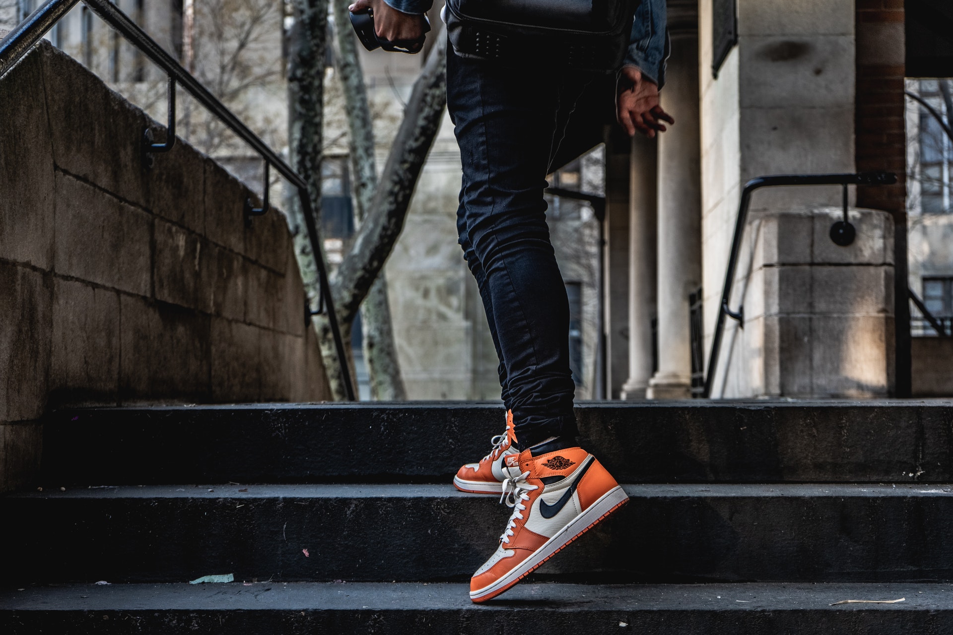 man wearing orange sneakers