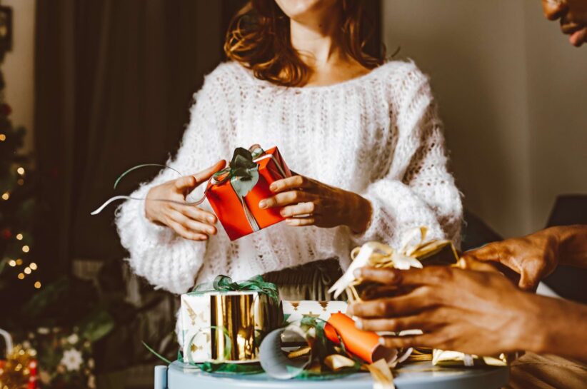 woman in a sweater with presents